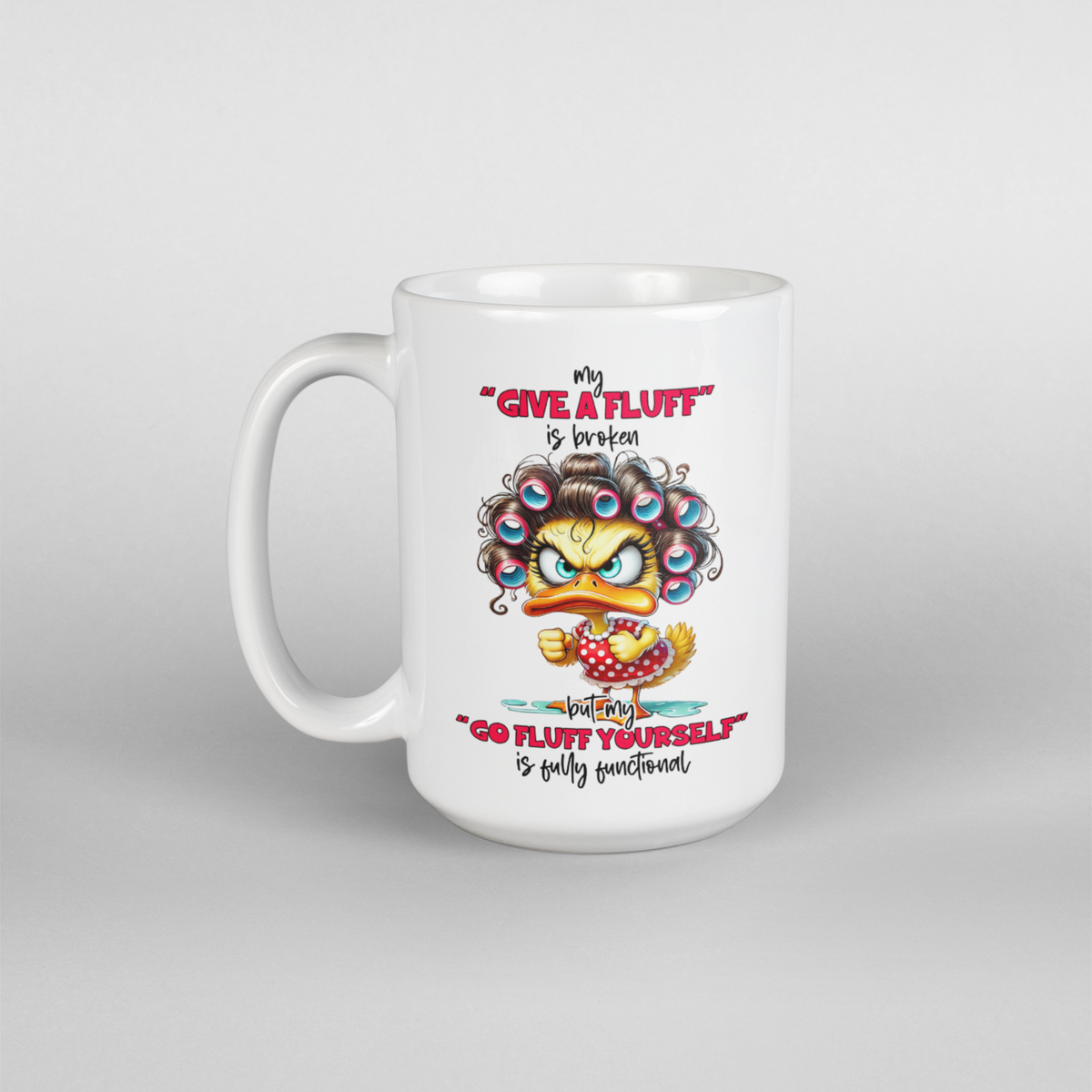 A white coffee mug with a mad female duck saying my "give a fluff" is broken " go fluff yourself" is fully functional