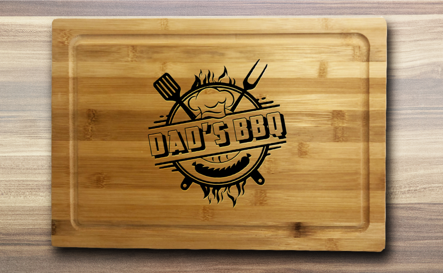 a laser engraved bamboo cutting board with Dad's BBQ and utensils in the middle
