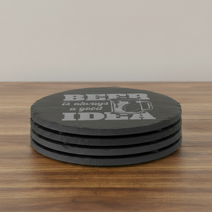 A round black coaster with a textured finish featuring the phrase 'BEER is always a good IDEA' in gray lettering alongside an illustration of a frothy beer mug, shown on a plain white background.
