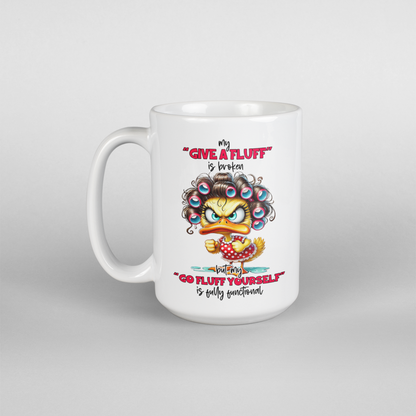 A white coffee mug with a mad female duck saying my "give a fluff" is broken " go fluff yourself" is fully functional
