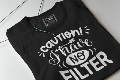 A black folded t shirt with white writing caution I have no filter