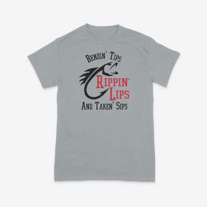 A grey t shirt with a fish and a quote that says Bendin' Tips Rippn' Lips and taken' sips