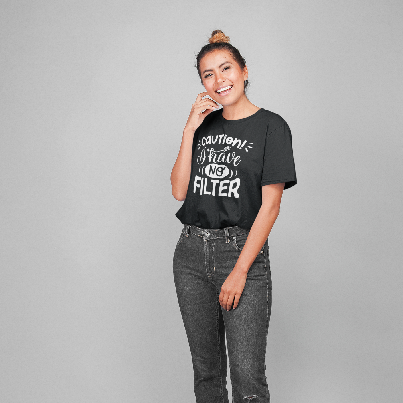 A happy woman wearing flared jeans and a black t shirt with white writing caution I have no filter